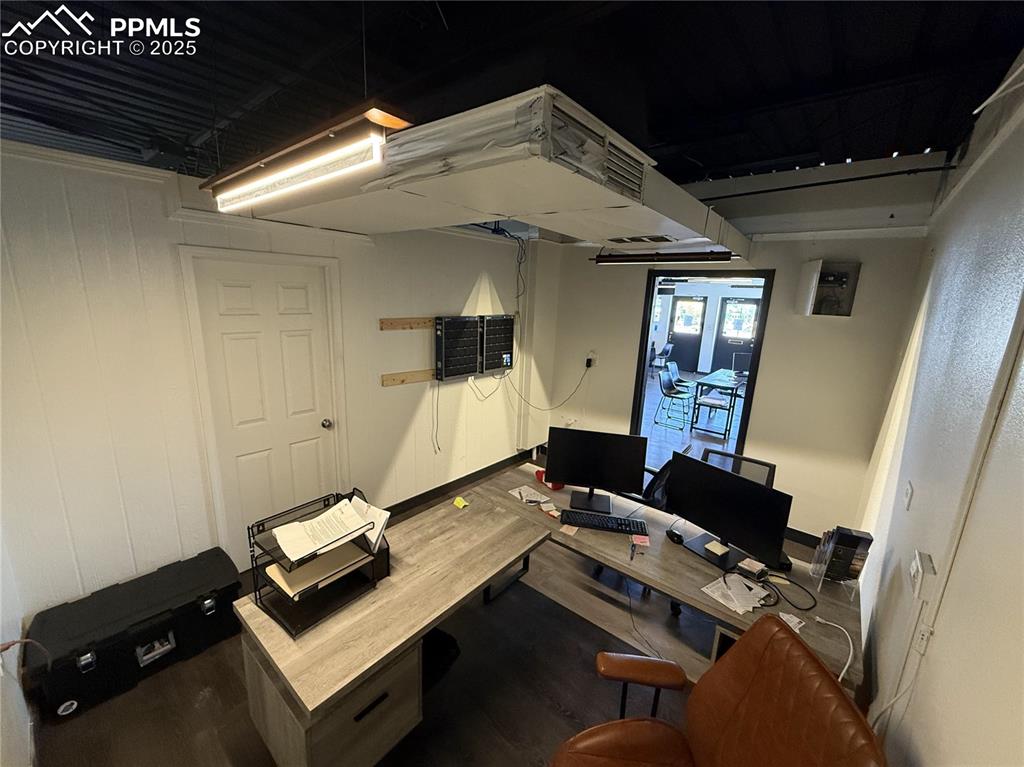 Image 10 of 28: Office area featuring wood finished floors and baseboards