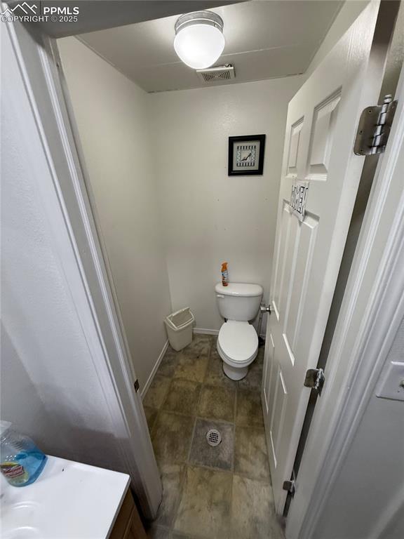 Image 26 of 28: Bathroom with toilet and vanity