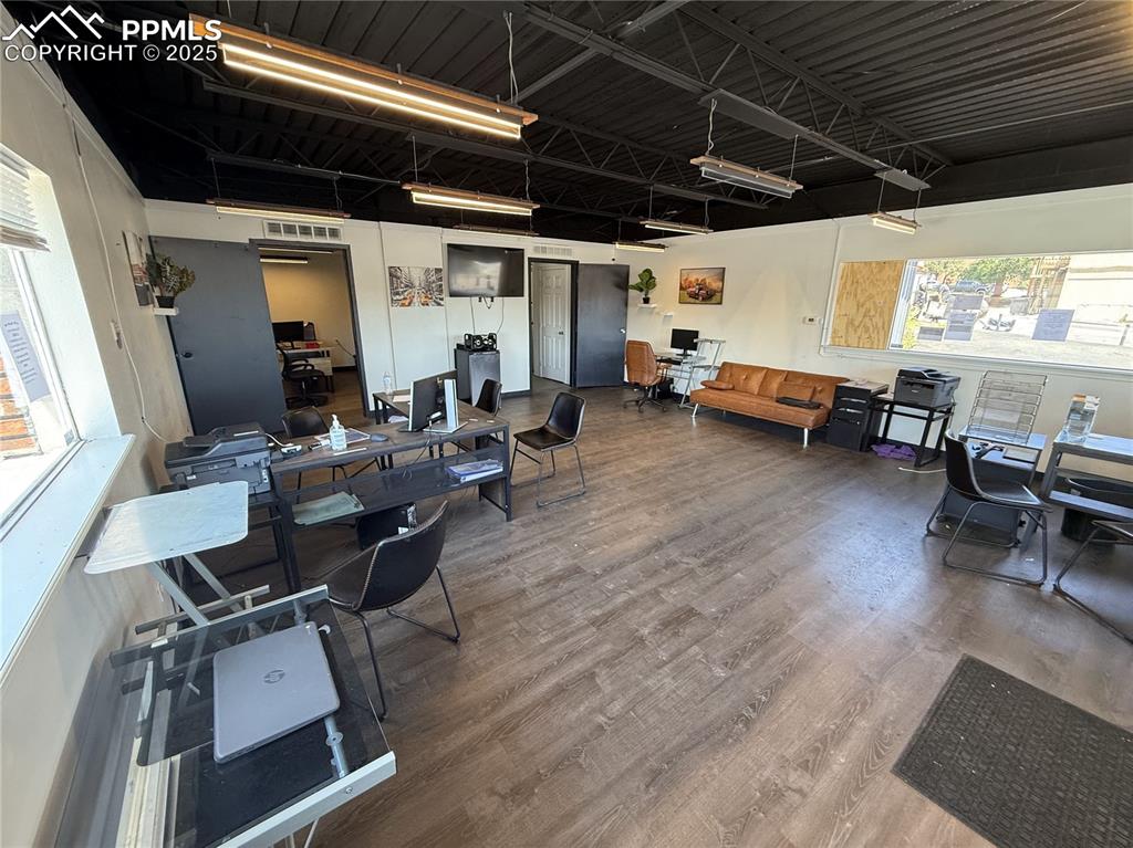 Image 7 of 28: Miscellaneous room with wood finished floors