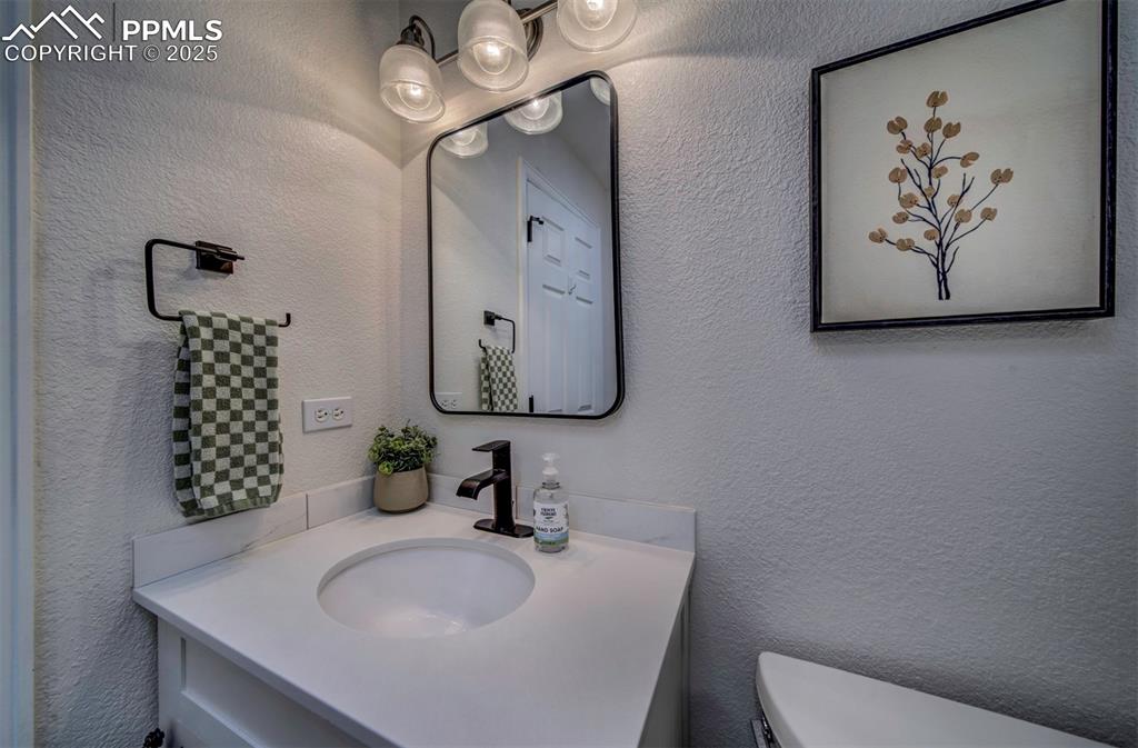 Image 23 of 30: Bathroom featuring a textured wall and vanity