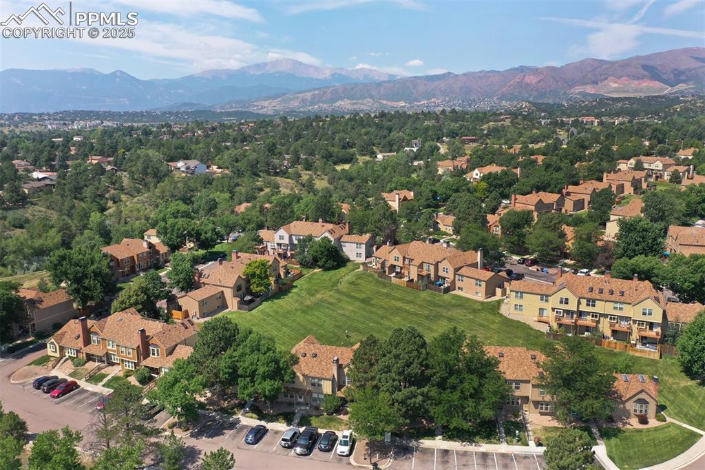 Image 28 of 30: Aerial perspective of suburban area with a mountain backdrop