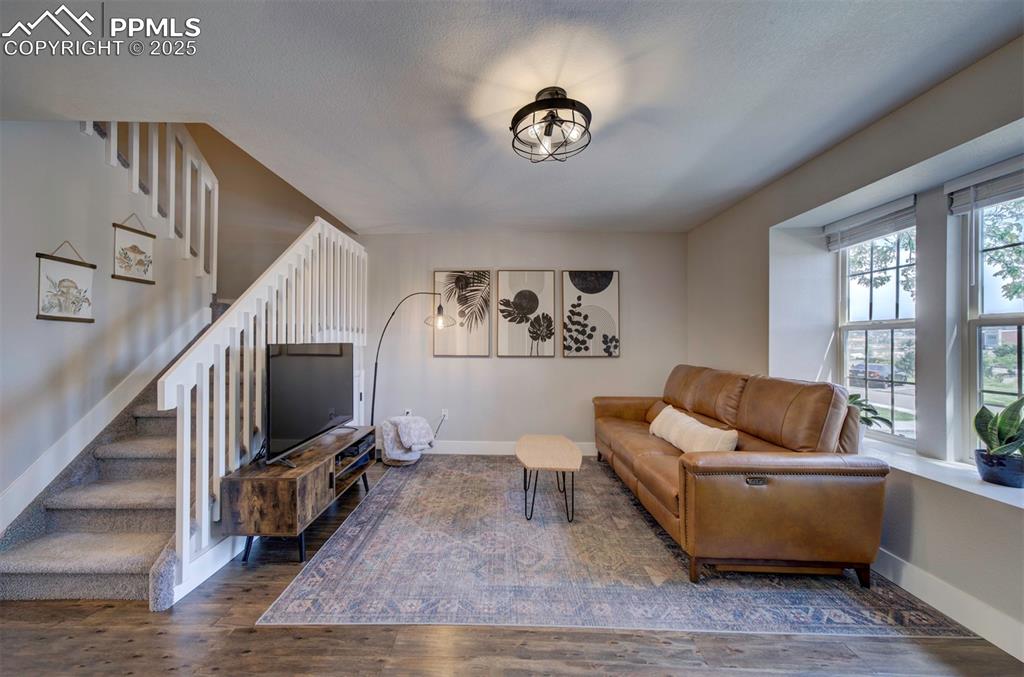Image 3 of 30: Living area with hardwood / wood-style floors and stairs