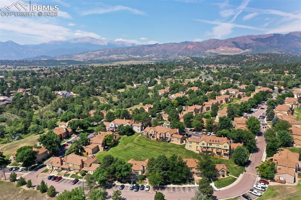 Image 30 of 30: Aerial view of residential area with a mountain backdrop