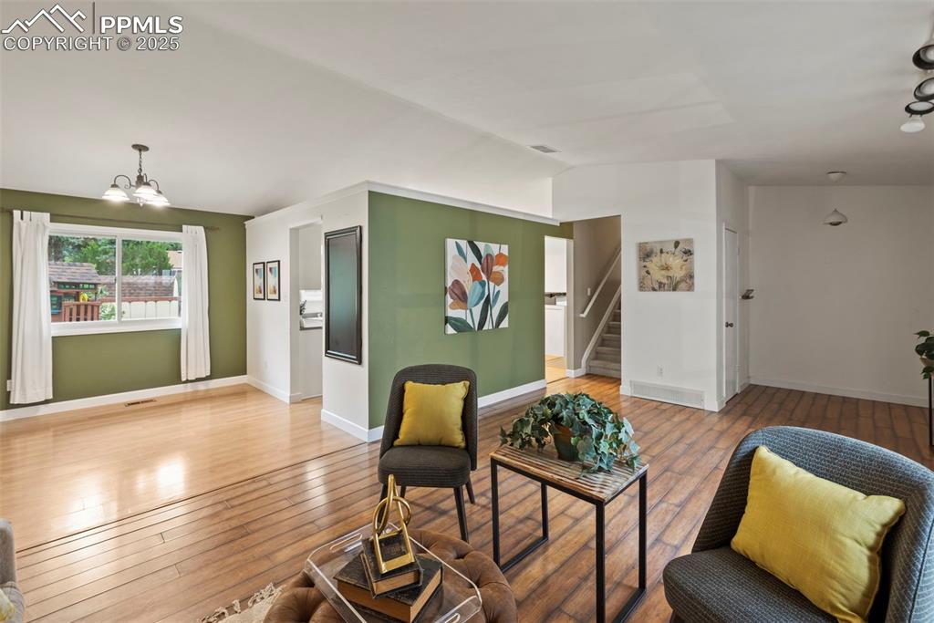 Image 2 of 49: Living room with dining room.