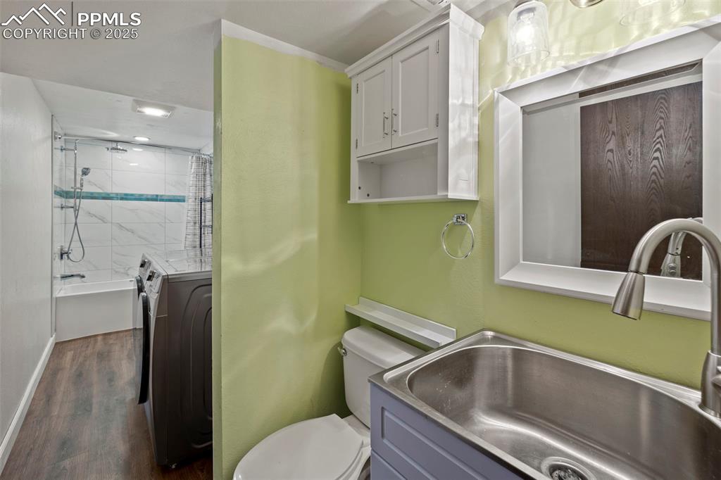 Image 32 of 49: Bathroom Laundry Combo off lower level.