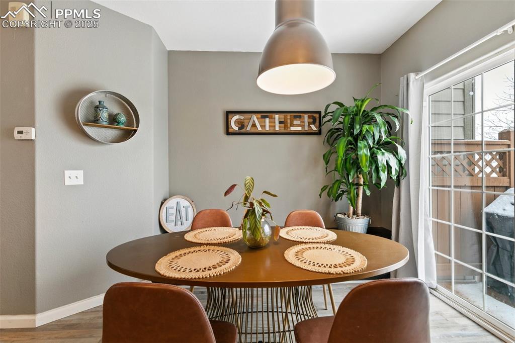 Image 10 of 36: Dining space featuring wood finished floors and baseboards