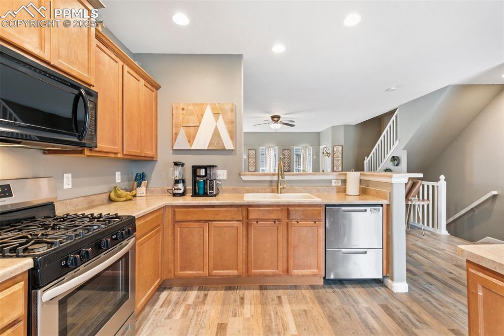 Image 16 of 36: Kitchen featuring stainless steel appliances, a sink, a ceiling fan, a peni
