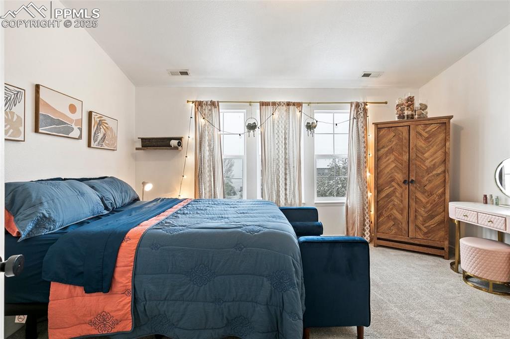 Image 20 of 36: Bedroom with light carpet