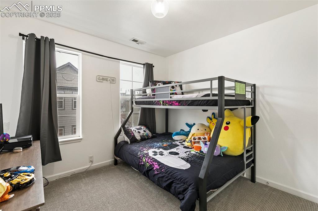 Image 26 of 36: Carpeted bedroom with baseboards