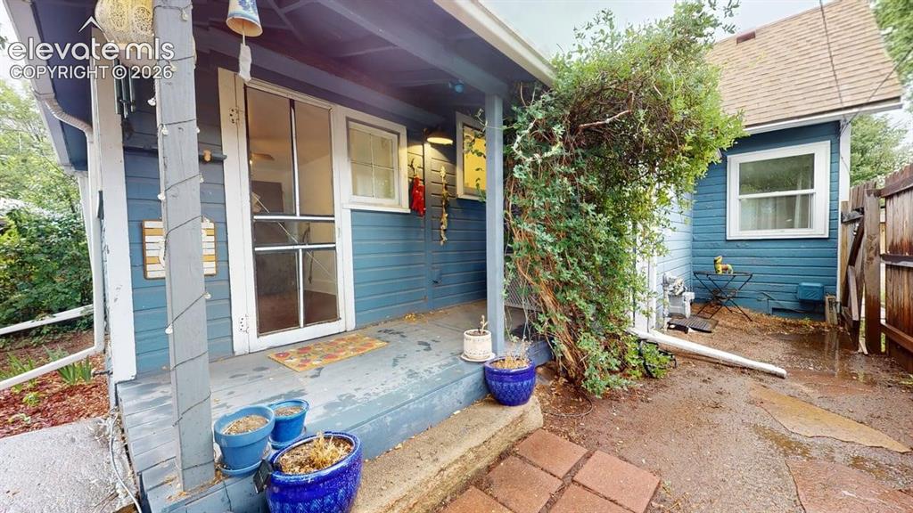 Image 36 of 49: Back porch and side yard