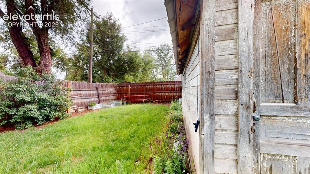 Image 43 of 49: Garage and another side yard