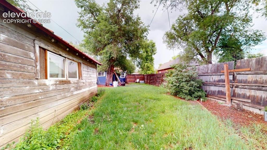 Image 45 of 49: Garden and side yard of garage