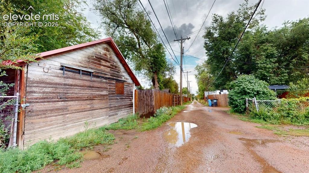 Image 46 of 49: Alley view of garage entry