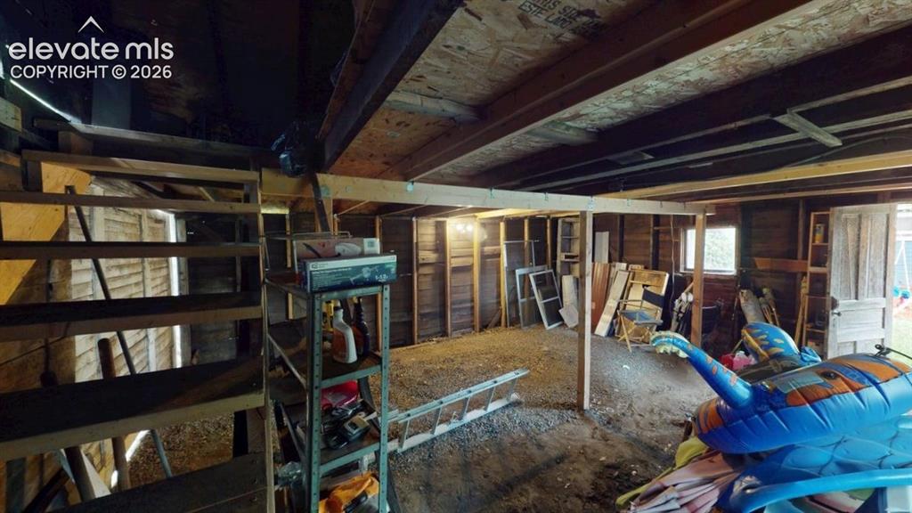 Image 49 of 49: Stairs to upper storage in garage