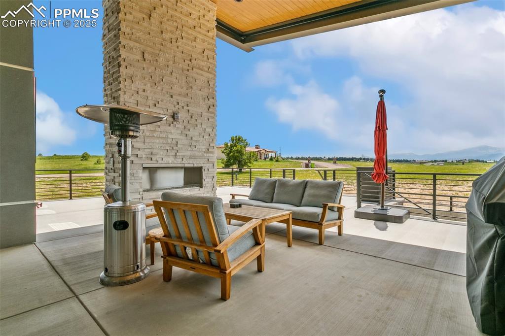 Image 14 of 50: Large patio with partial cover and fabulous gas fireplace