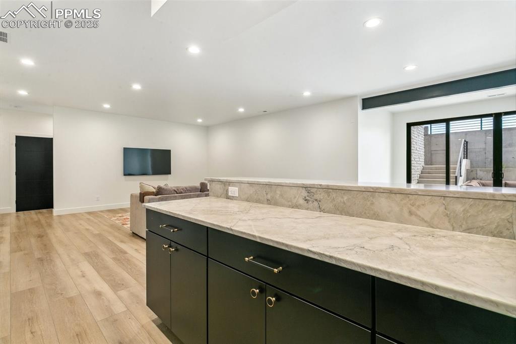 Image 36 of 50: Wet bar area in walk out basement