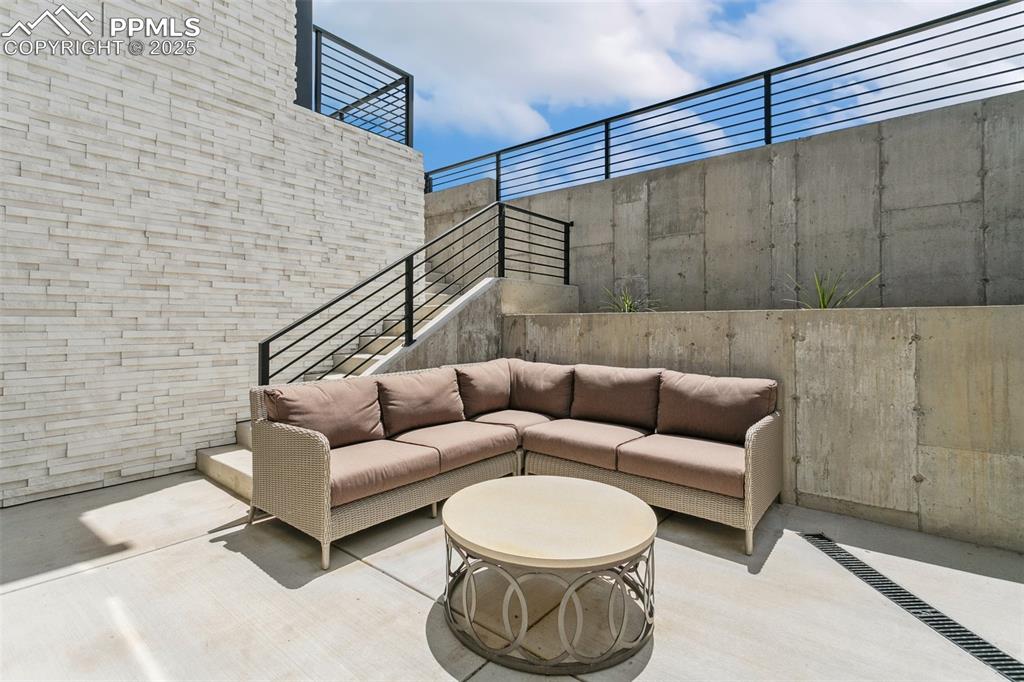 Image 38 of 50: Walk out heated courtyard with heated stairs to back patio