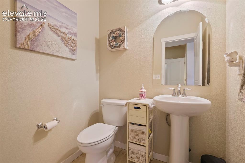 Image 12 of 33: Main Level: Bathroom featuring a pedestal sink with chrome faucet, arched m