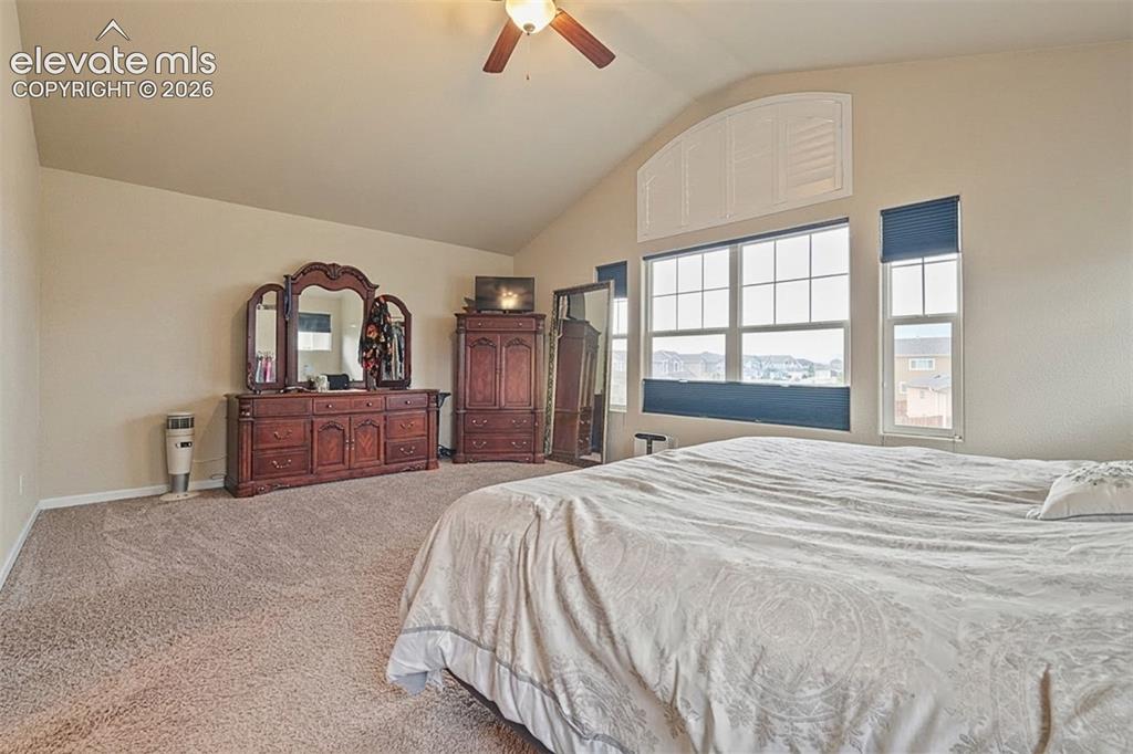 Image 14 of 33: Upper Level: Vaulted ceiling with a ceiling fan and overhead lighting