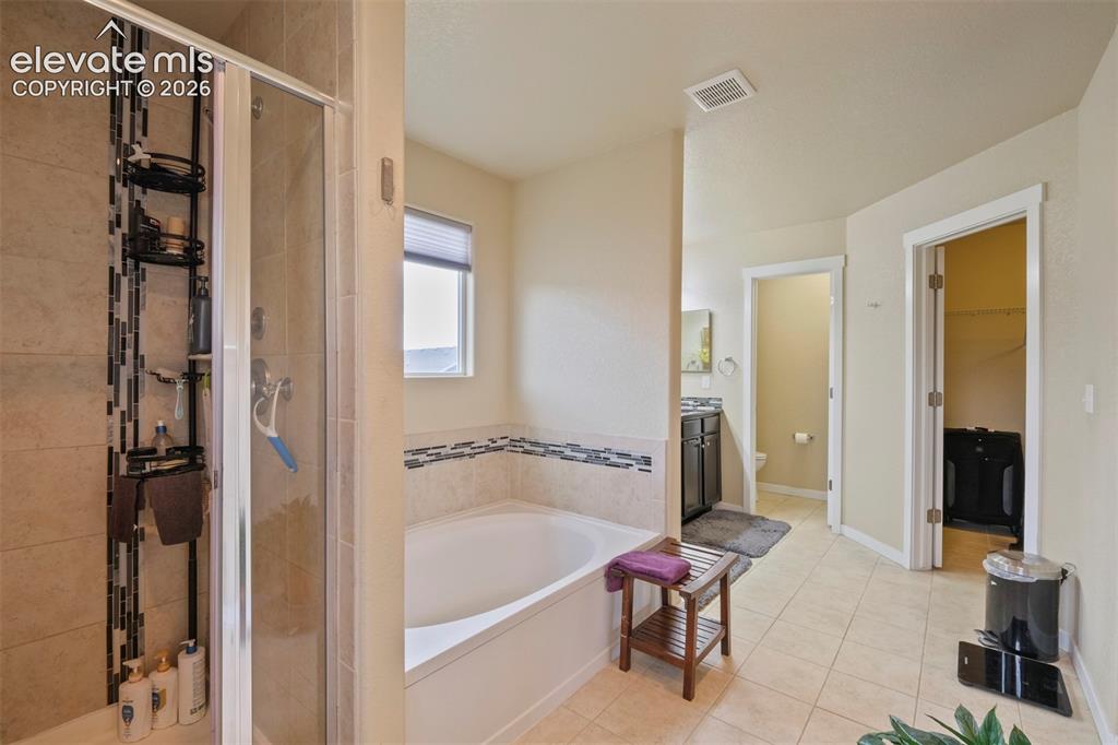 Image 16 of 33: Upper Level: Tiled flooring and light-toned walls throughout this bathroom