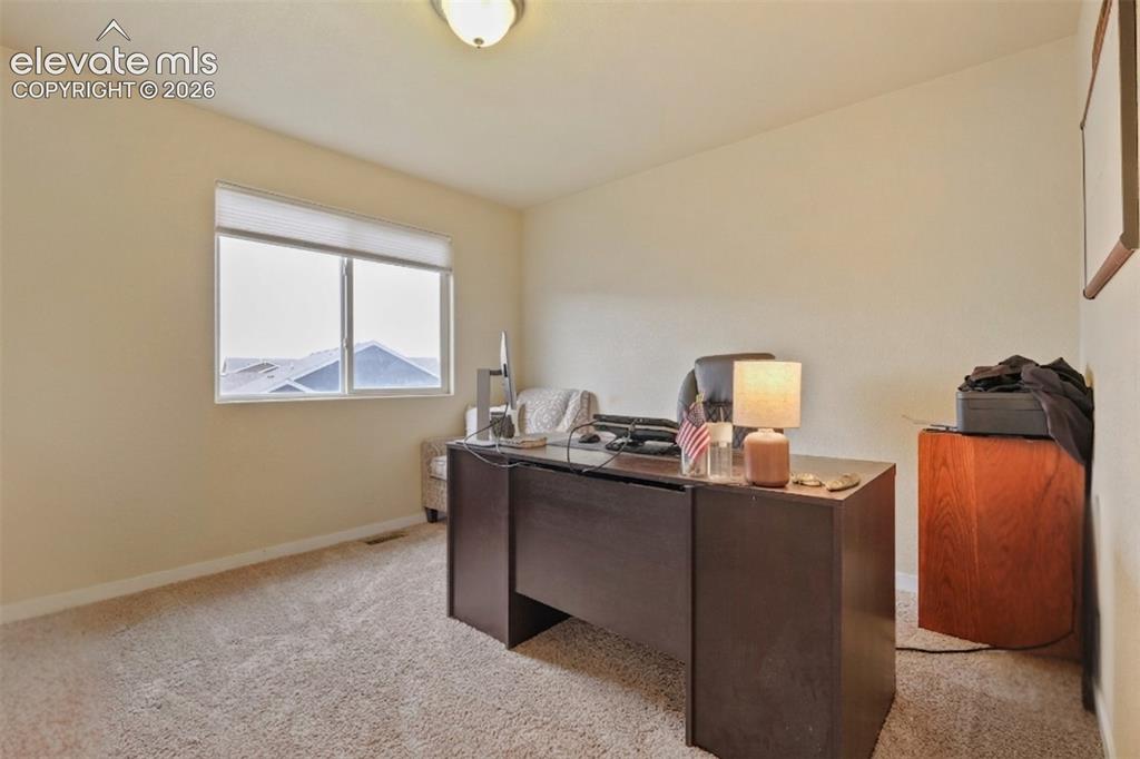 Image 20 of 33: Upper Level: bedroom featuring a double window with blinds, neutral carpeti