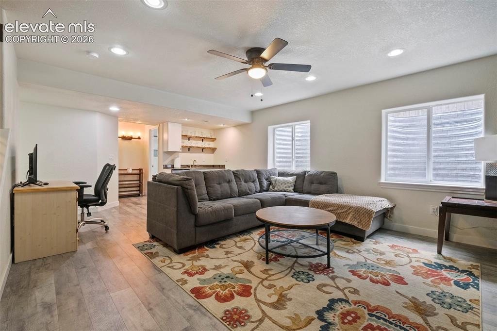 Image 24 of 33: Basement: Open-concept living area featuring wood-finish flooring, recessed