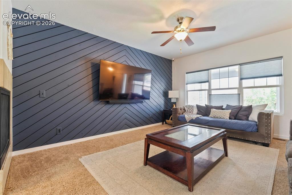 Image 7 of 33: Main Level: Living space featuring a striking accent wall with a diagonal w
