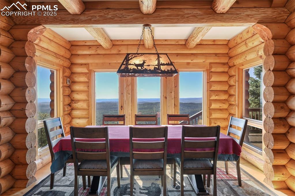 Image 17 of 50: Unfurnished dining area featuring a mountain view, wood finished floors, a 