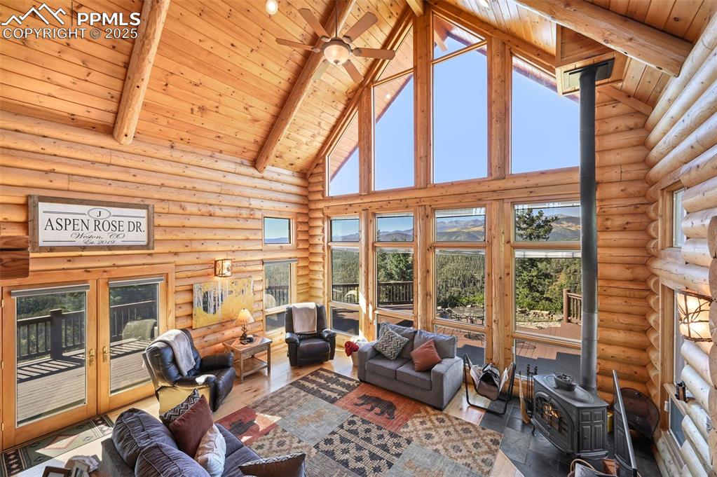 Image 26 of 50: Living room featuring high vaulted ceiling, beam ceiling, wood ceiling, woo