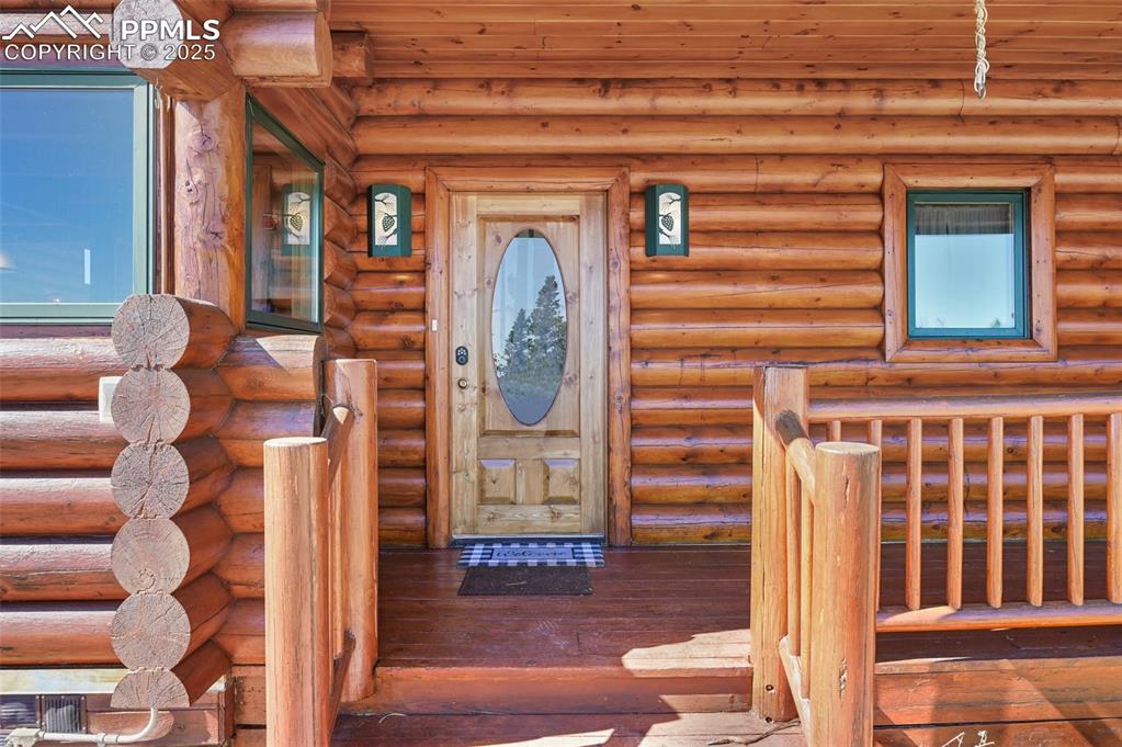 Image 8 of 50: Entrance to property with log siding