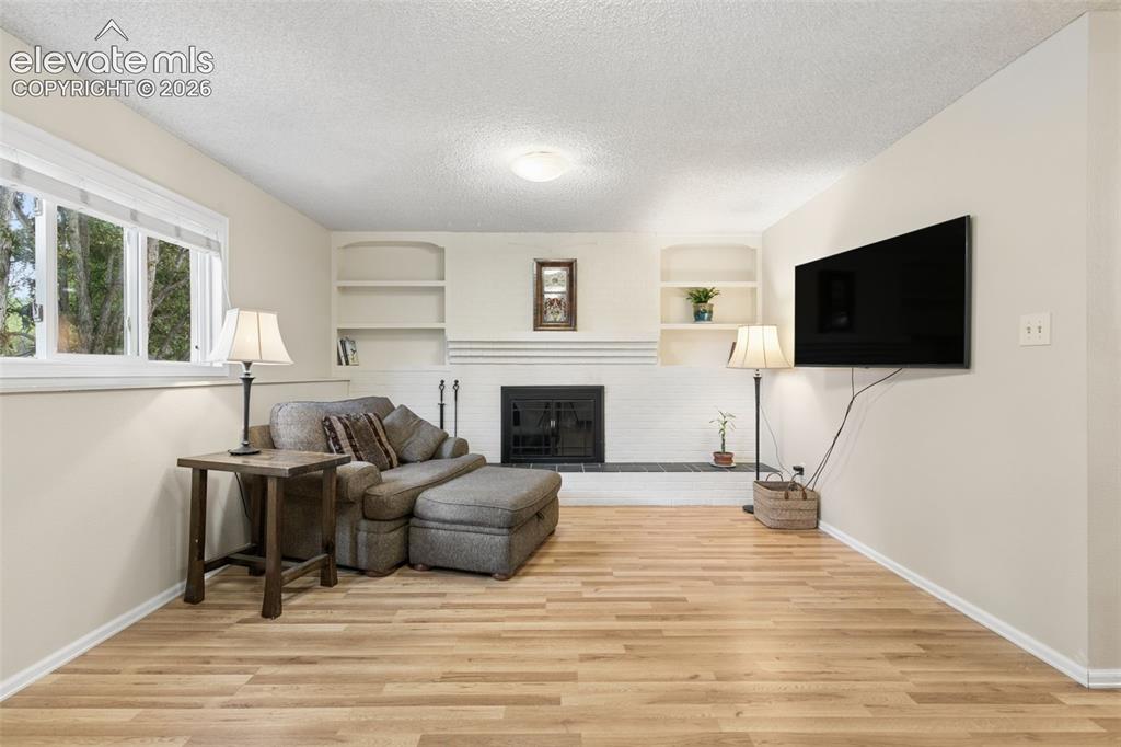 Image 19 of 48: Brick mantle and hearth with built-ins