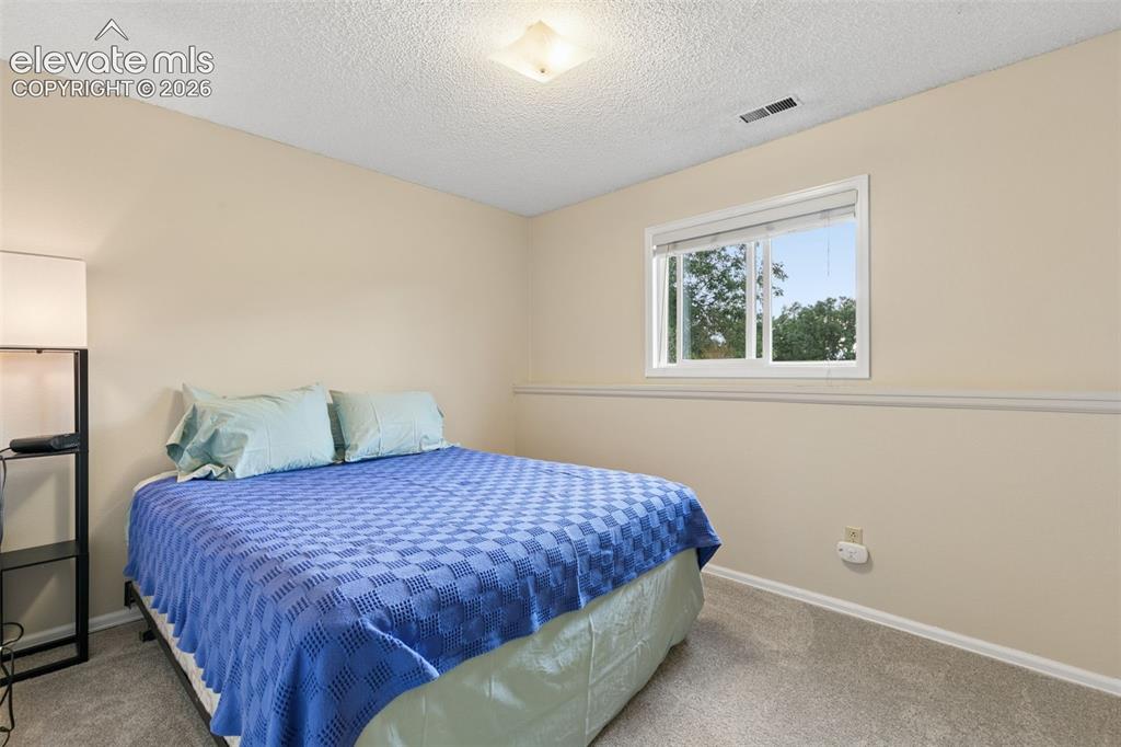 Image 21 of 48: Bedroom is off the family room with bathroom across the hall