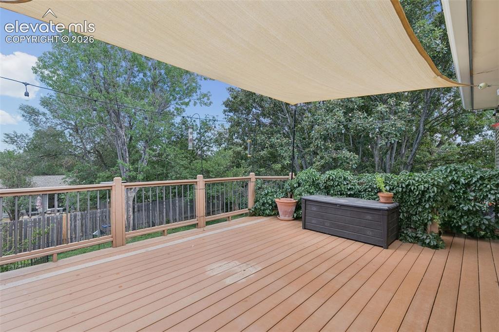 Image 6 of 48: 19 x 14 composite deck overlooking the gardens huge yard.