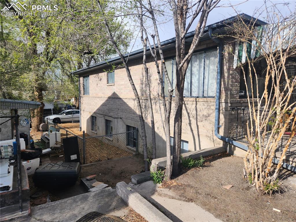 Image 19 of 22: View of property exterior featuring brick siding