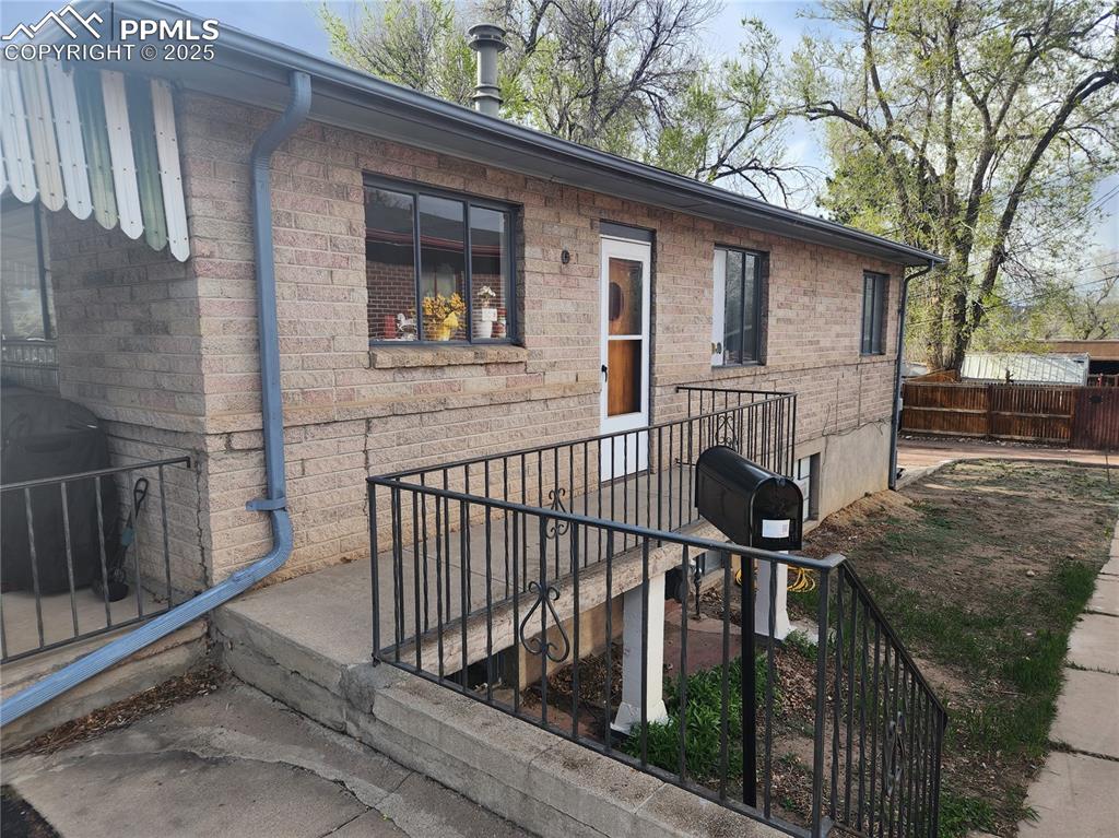 Image 20 of 22: Doorway to property with brick siding