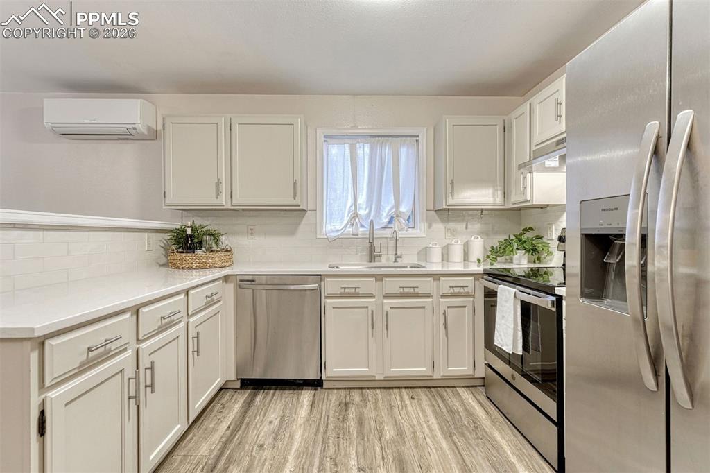 Image 4 of 30: Remodeled kitchen with quartz countertops