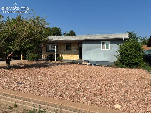 Image 3 of 16: Low-maintenance front landscape with mature desert vegetation and gravel ha