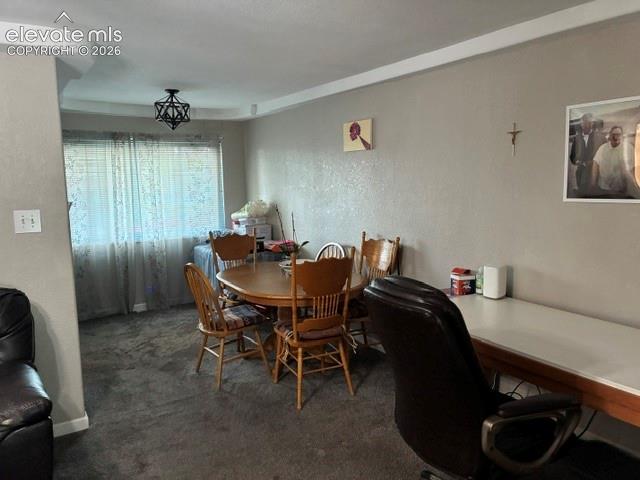 Image 7 of 16: Spacious dining area with wood-finish flooring, neutral wall finishes, and