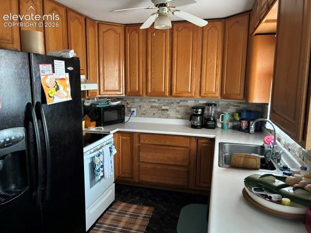 Image 9 of 16: Warm wood cabinetry with raised-panel doors and ample storage, complemented