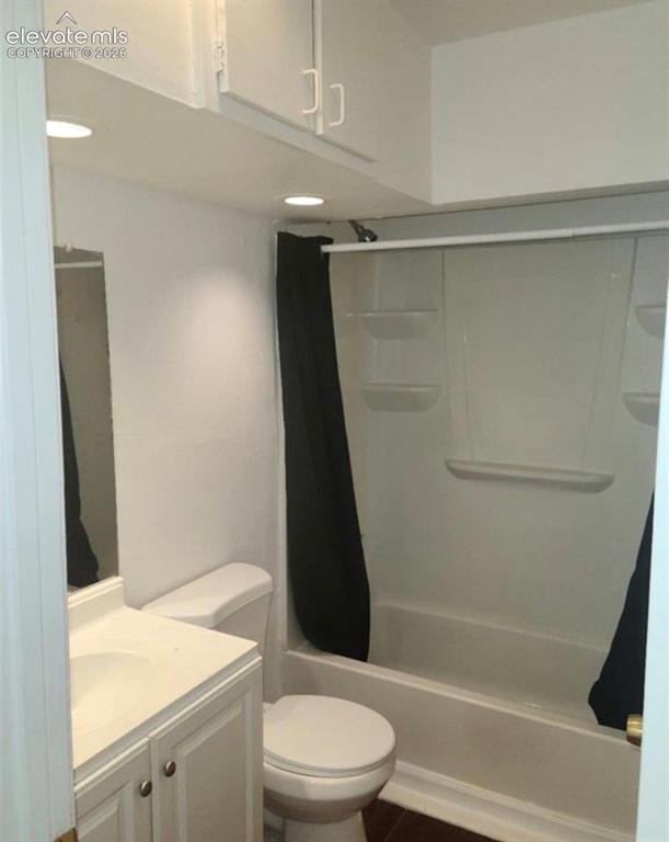 Image 7 of 9: Full bathroom featuring a white vanity with integrated sink, white toilet,