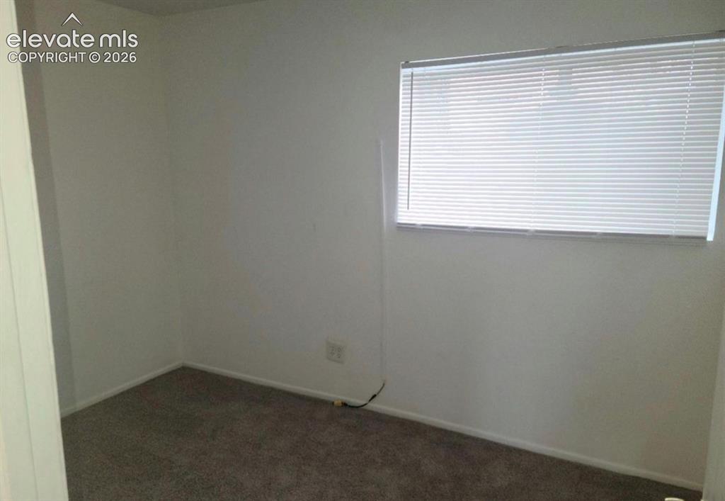 Image 9 of 9: Window with horizontal blinds, light gray wall paint, white baseboards, and