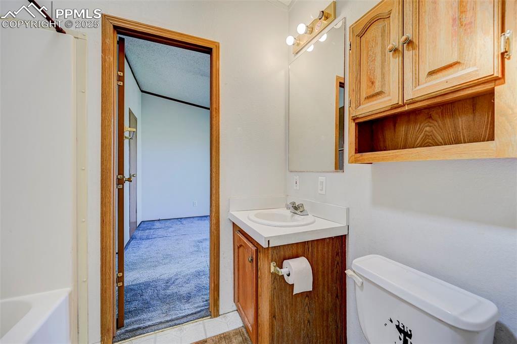 Image 33 of 48: Full bath featuring vanity, toilet, a tub to relax in, and a shower