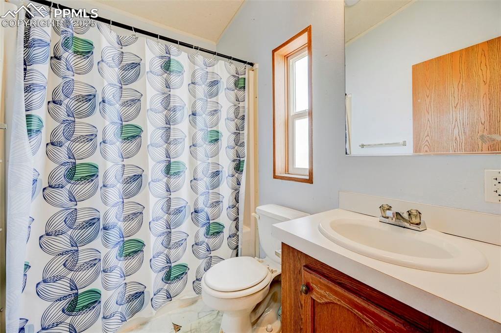Image 37 of 48: Full bath with vanity, toilet, and a shower with curtain