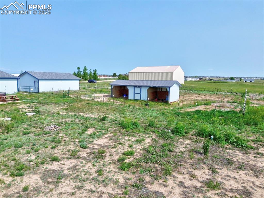 Image 5 of 48: View of yard featuring an outbuilding and a rural view
