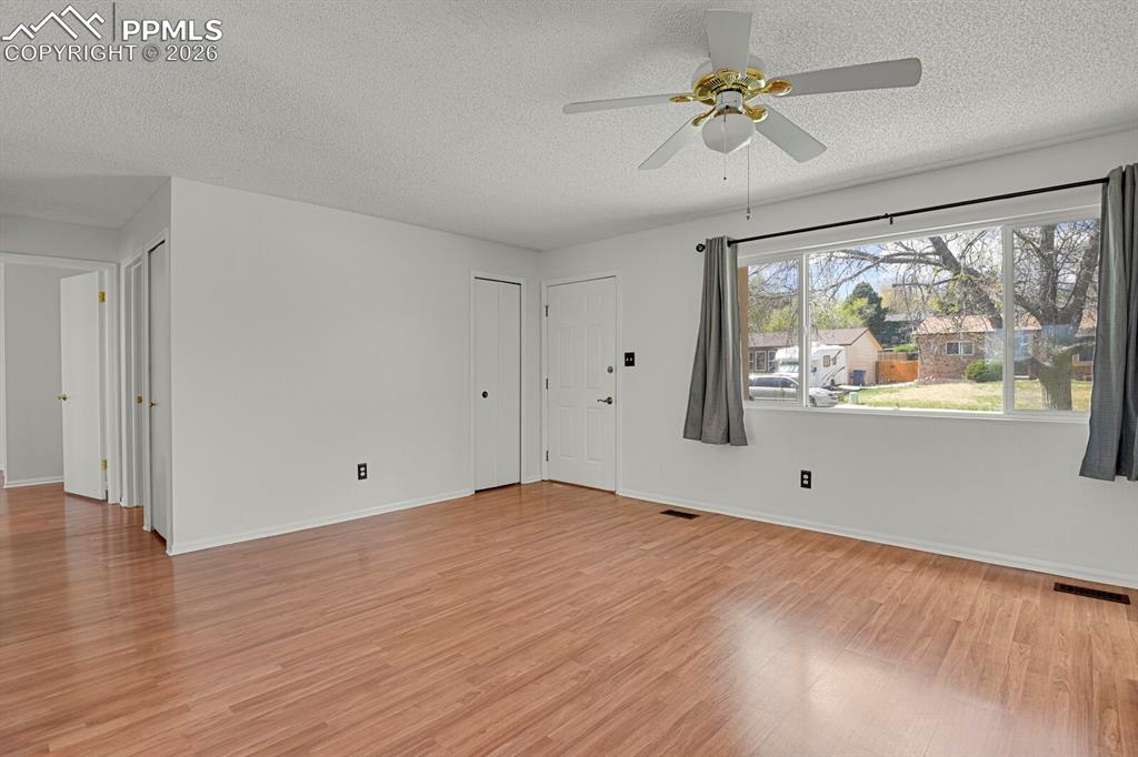Image 5 of 31: Empty room featuring a ceiling fan, light wood-type flooring, and a texture