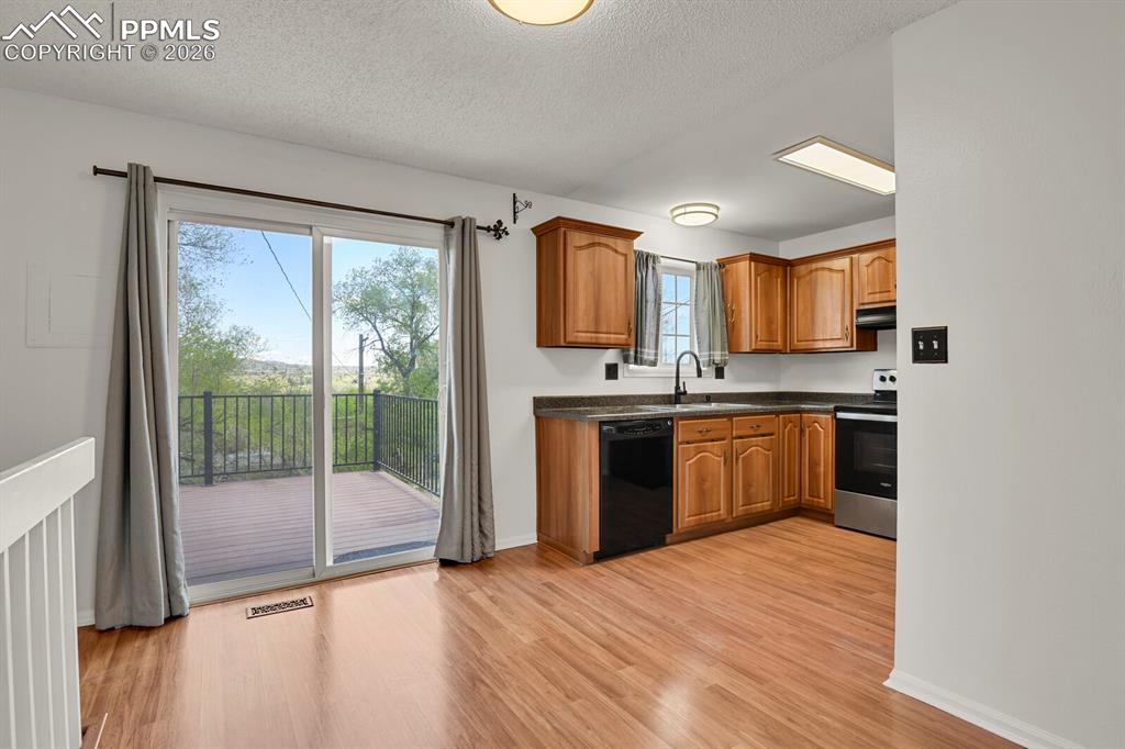Image 8 of 31: Kitchen featuring wood finish cabinetry, stainless steel range with electri