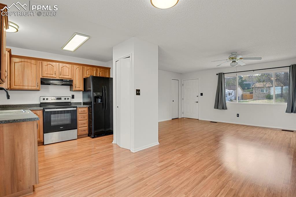 Image 9 of 31: Kitchen featuring dark countertops, stainless steel range with electric sto