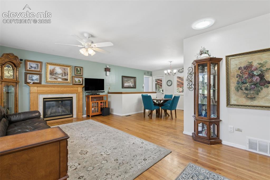 Image 12 of 48: Main living room with natural hardwood floors