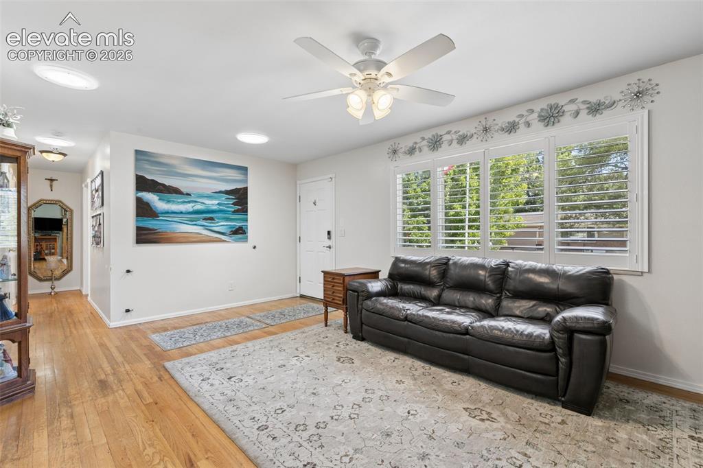 Image 14 of 48: Main living room with natural hardwood floors