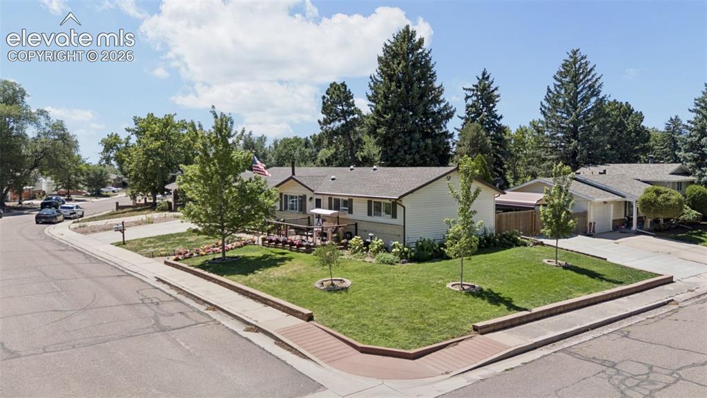 Image 2 of 48: Corner lot with side driveway and gated carport parking
